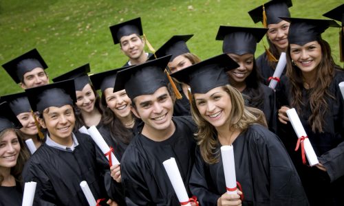 group of graduation students in the park looking happy